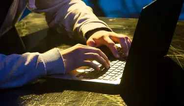 hooded-computer-hacker-stealing-information-with-laptop(1)